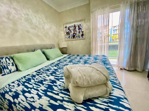 a bedroom with an elephant chair on a bed at Radiant Realm Residence Free Parking BBQ Central los Corales in Punta Cana