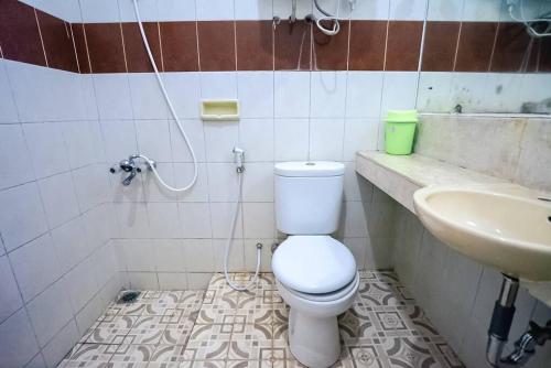 a bathroom with a toilet and a sink at The Haven by Vila Istana Bunga in Bandung
