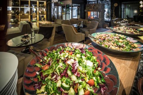 a table with two plates of salad on it at Lapland Hotels Oulu in Oulu