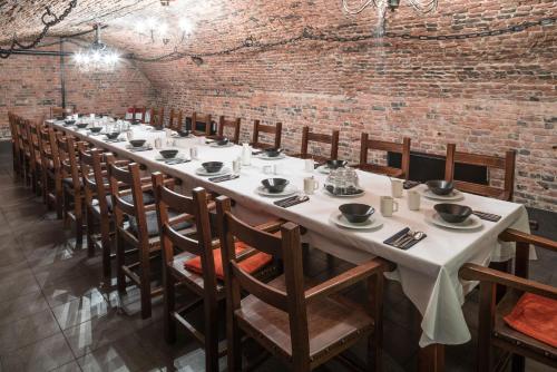 a long table in a room with a brick wall at Lapland Hotels Oulu in Oulu