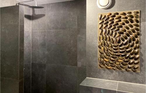 a bathroom with a shower with a metal wall at Beautiful Apartment In Bruinisse in Bruinisse