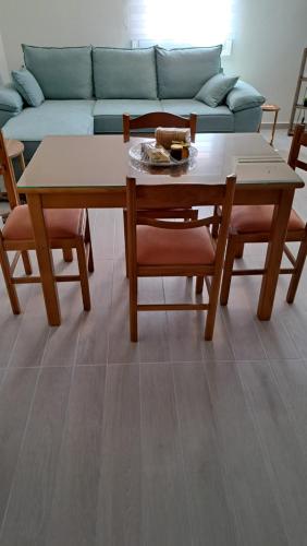 a table and chairs in a living room with a couch at Ανεμώνη Αράχωβα in Arachova
