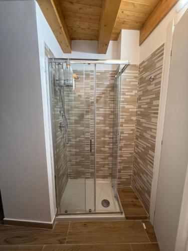 a shower with a glass door in a bathroom at B&B La Ginestra in Bova