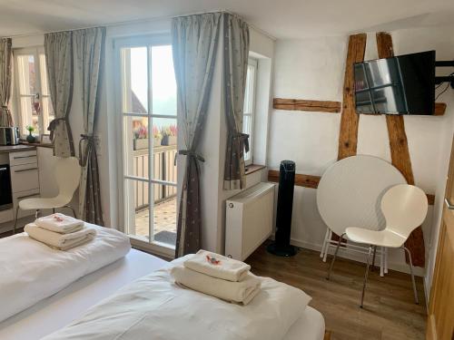 a hotel room with two beds and a window at Gästehaus am Plönlein in Rothenburg ob der Tauber