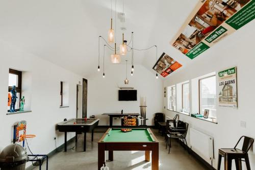 a living room with a ping pong table in it at POPPY LUXURY LODGE Sleeps 8 at Fairview Farm, Ravenshead, Nottingham Near Sherwood Forest, Dog Friendly, Farm Stay great for wedding groups, families, Hen Do's, friends gatherings with amazing views in Blidworth