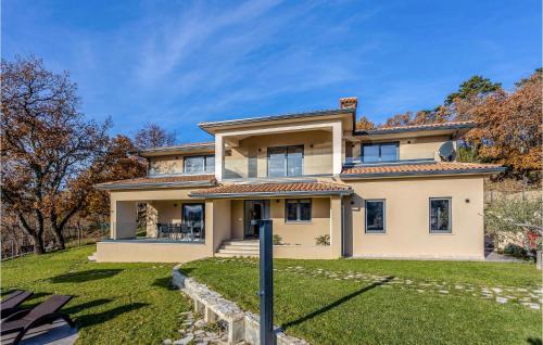 a large yellow house with a grass yard at Awesome Home In Boljun With Wifi in Boljun