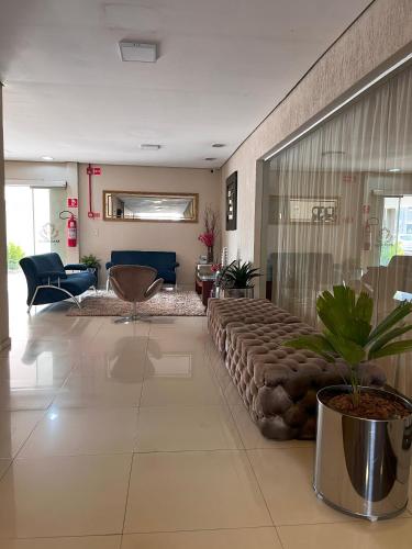 a living room with a large couch in the middle at Maximus Sottile Hotel in Ji-Paraná