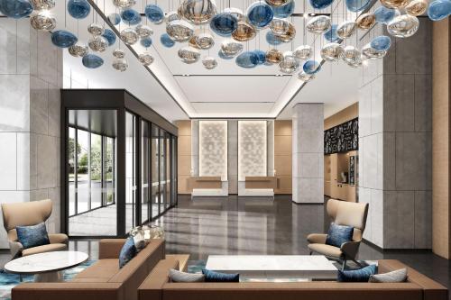a lobby with blue and white plates on the ceiling at Fairfield by Marriott Hangzhou Qiantang in Hangzhou