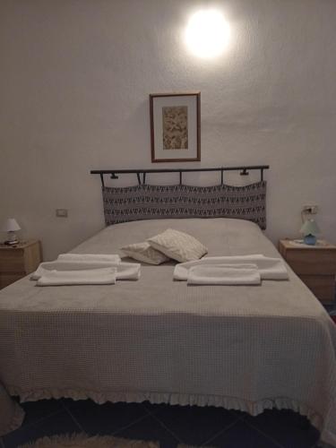 a bedroom with a bed with two towels on it at Affittacamere da Liliana in San Teodoro