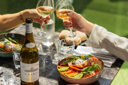 a table with a bowl of food and a bottle of wine at Novotel Lyon Gerland Musée des Confluences in Lyon