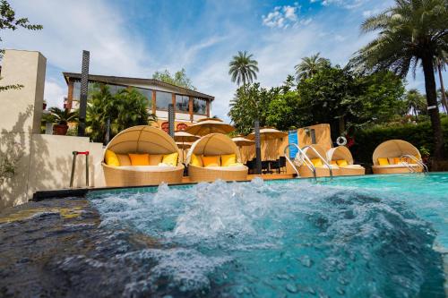 a water slide in a pool at a resort at Chacha Inn The Garden Retreat in Mount Ābu