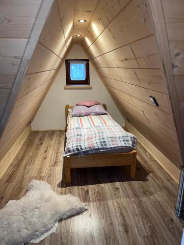 a small bed in the middle of a attic at U kowalczyków in Groń