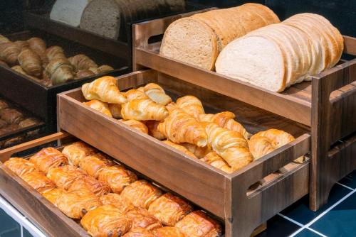 a bunch of loaves of bread on trays in a bakery at Holiday Inn Express Antrim by IHG in Antrim
