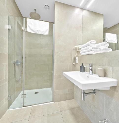 a bathroom with a sink and a shower at Residence Dlouha - Old Town in Prague