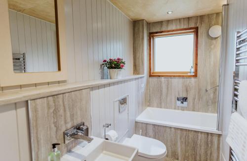 a bathroom with a sink and a toilet and a mirror at Lodge 11 in Wareham