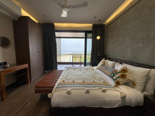 a bedroom with a large bed with a teddy bear on it at Dolce Villa IGATPURI in Igatpuri