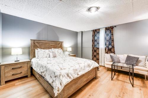 a bedroom with a large bed and a chair at Lakefront Guest Suite Near Richmond in Richmond