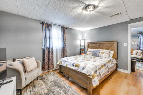 a bedroom with a bed and a couch and a chair at Lakefront Guest Suite Near Richmond in Richmond