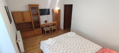 a bedroom with a bed and a table and chairs at Hotel Vyšehrad in Turčianske Teplice