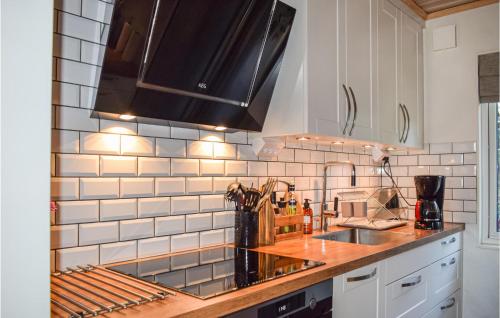 a kitchen with a sink and a counter top at Lovely Home In Lekeryd With Sauna in Lekeryd