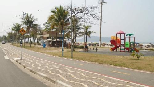 a street with a playground on the side of the road at Casa com piscina em Bertioga 700m da praia in Bertioga