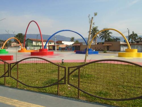 a playground with colorful rides in a park at Casa com piscina em Bertioga 700m da praia in Bertioga