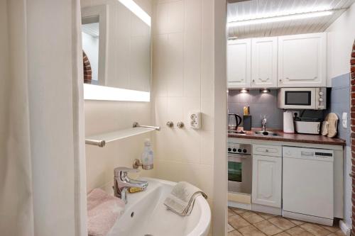 a bathroom with a sink and a bath tub at Haus Lith Deichblick in Nordstrand