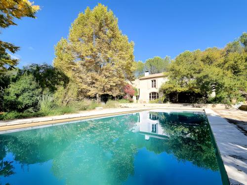 a swimming pool in front of a house at Mas Des Cigales Lambesc in Lambesc