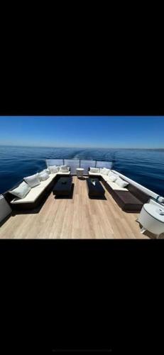 a television screen with chairs and tables on a boat at Sail & Stay in Castillo de Sabinillas