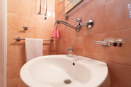 a bathroom with a white sink and a mirror at Apartments Din in Kukljica