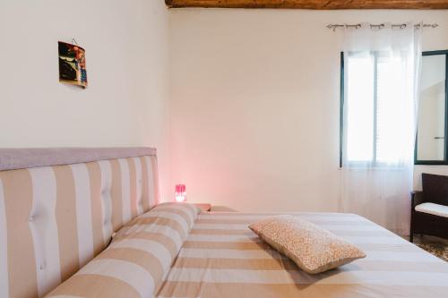a bed with a pillow on it in a room at Da Giovanni A Custonaci in Custonaci
