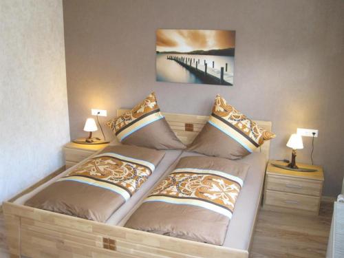 a bedroom with a bed with pillows on it at B&U Fewo Scherhag in Alken