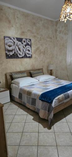 a bedroom with a large bed in a room at MARY ROSE - Locazione Turistica in Brindisi