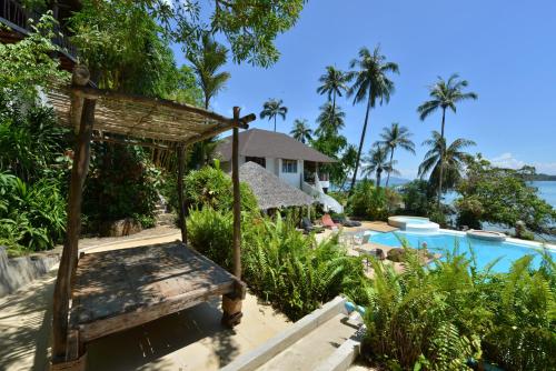 a view of a resort with a pool and a bed at Koh Mak Cococape Resort in Ko Mak