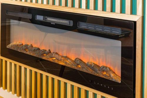 a oven with a fire inside of it at Modern apartment 5 mins walking to the Santuary in Fátima