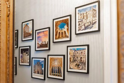 a group of framed pictures on a wall at Modern apartment 5 mins walking to the Santuary in Fátima