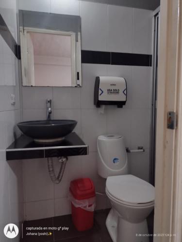 a small bathroom with a sink and a toilet at Hotel campestre París soleil in Mariquita