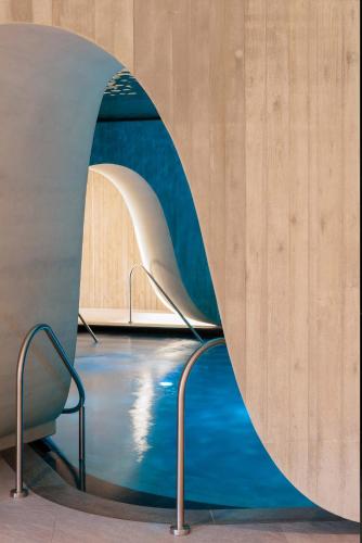 a circular hallway with a pool of water in a building at Hotel Krallerhof in Leogang