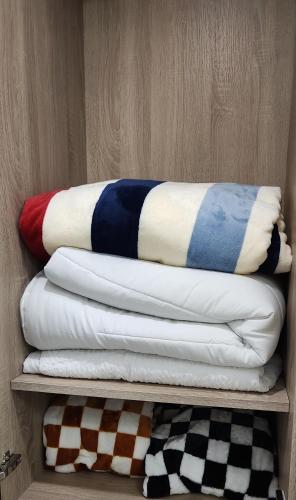 a group of pillows sitting on a shelf at 반달섬드림스테이 오이도벚꽂여행 힐링복층 시화호노을구경 in Ansan