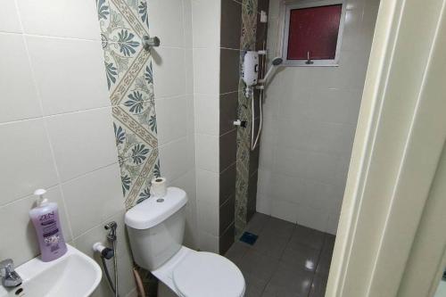a bathroom with a toilet and a sink at Kamilia Homestay Anderson Ipoh in Kampong Simee