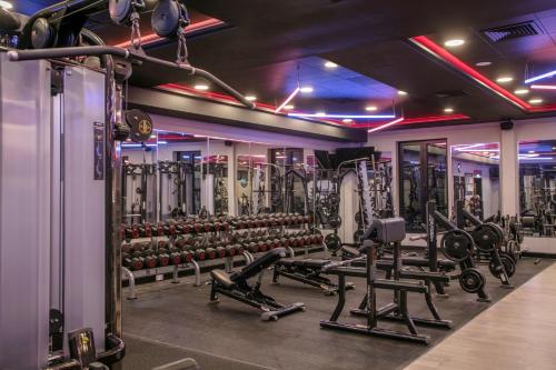 a gym with several rows of weight machines at Hampshire Court Hotel & Spa in Basingstoke