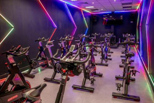 a gym with rows of exercise bikes in a row at Hampshire Court Hotel & Spa in Basingstoke