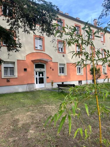 a building with a bench in front of it at PlatánWood ComfortHome in Zalaegerszeg