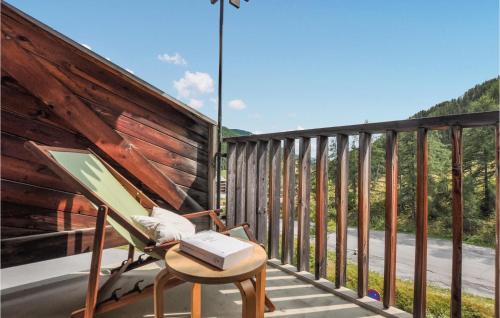 une chaise sur une terrasse munie d'un ordinateur portable dans l'établissement 1 Bedroom Beautiful Apartment In Allos, à Allos