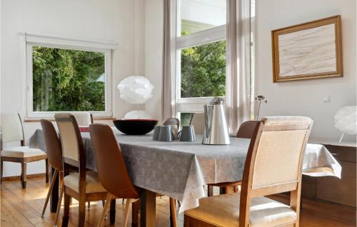 a dining room with a table and chairs at Three-Bedroom Holiday Home In Askeby in Askeby