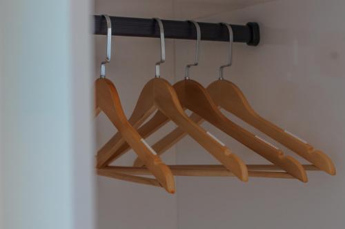 a bunch of wooden utensils hanging on a rack at Atoll Retreat in Fulidhoo