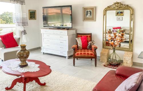 a living room with a dresser and a mirror at 2 Bedroom Cozy Home In Saint Chinian in Saint-Chinian