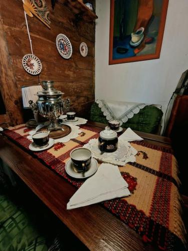 a table with a tea set on top of it at Ślimakowa chatka jak u babci in Parczew