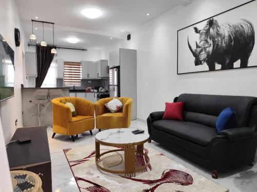 a living room with a couch and a table at Winslow Luxury apartments with Wifi connection and a gorgeous Lake sunset view in Kampala