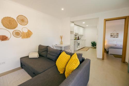 a living room with a couch and a bedroom at Tree House - Casa Limoeiro in Quinta do Conde